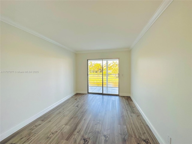 spare room featuring crown molding and light hardwood / wood-style flooring