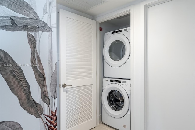 laundry area featuring stacked washer / drying machine