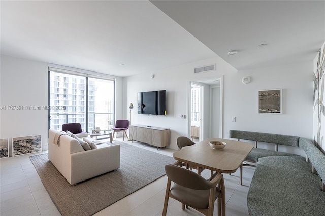 tiled living room with a wall of windows