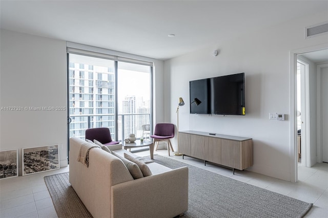 tiled living room with floor to ceiling windows and plenty of natural light