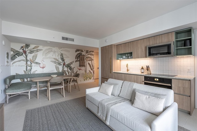 living room with sink and light tile patterned flooring