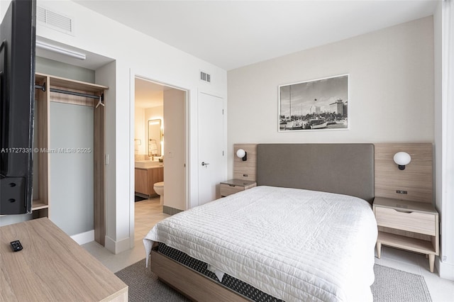 bedroom featuring ensuite bathroom and a closet