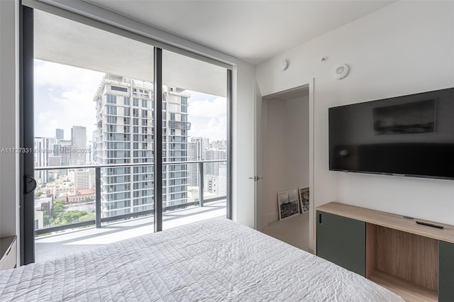 bedroom with floor to ceiling windows and access to exterior