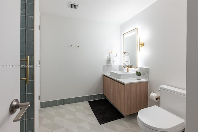 bathroom with toilet and vanity