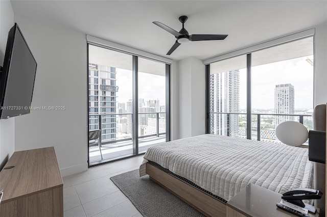 tiled bedroom with ceiling fan, a wall of windows, and access to outside