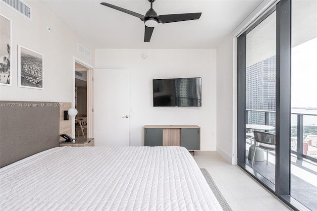 bedroom with ceiling fan, expansive windows, and access to exterior