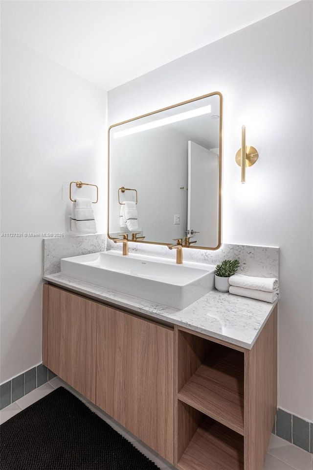 bathroom featuring tile patterned flooring and vanity