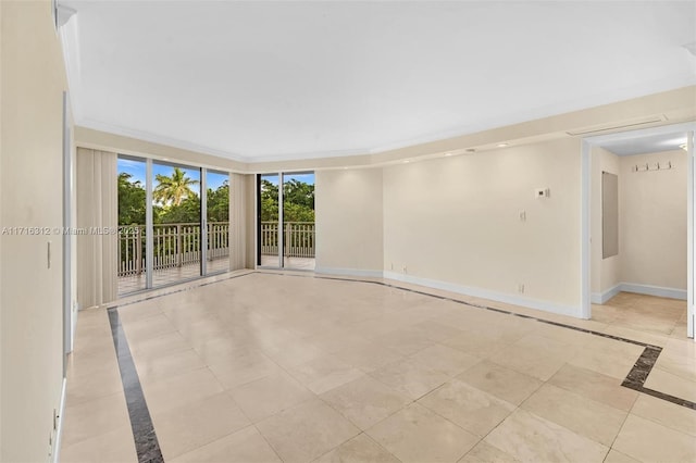 empty room with light tile patterned floors and ornamental molding