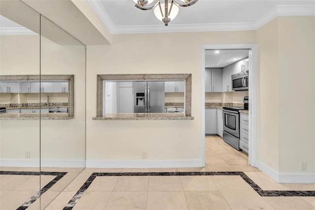 kitchen with light stone countertops, stainless steel appliances, an inviting chandelier, ornamental molding, and light tile patterned floors