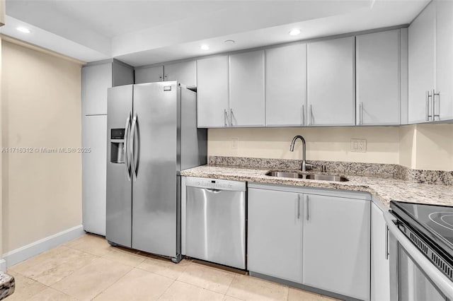 kitchen featuring light tile patterned floors, sink, light stone counters, and stainless steel appliances