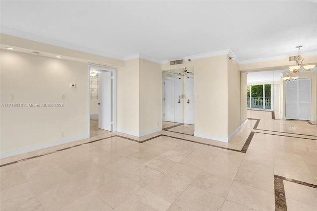 spare room featuring an inviting chandelier and crown molding