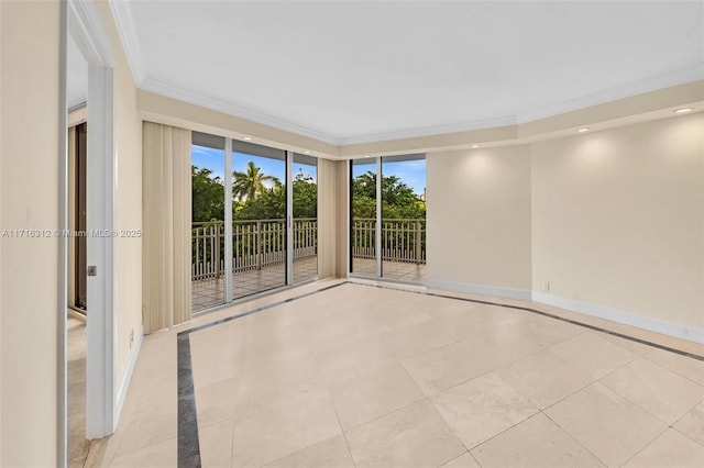 tiled spare room featuring ornamental molding