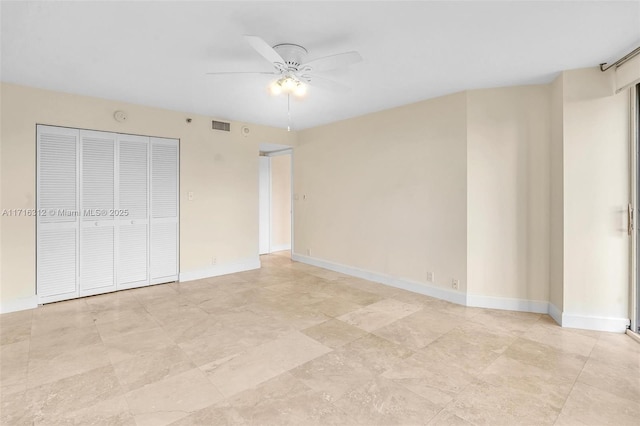 unfurnished bedroom with ceiling fan and a closet