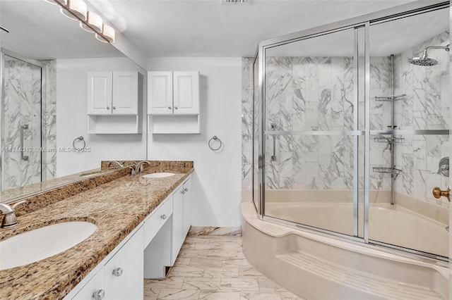 bathroom featuring combined bath / shower with glass door and vanity