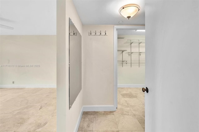 hall featuring light tile patterned floors