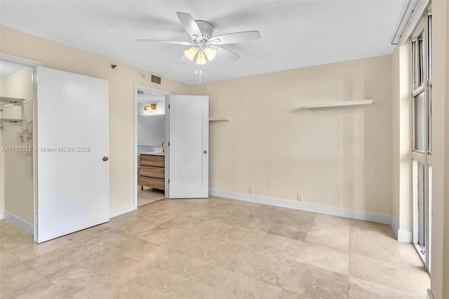 unfurnished bedroom featuring ceiling fan, a spacious closet, and a closet