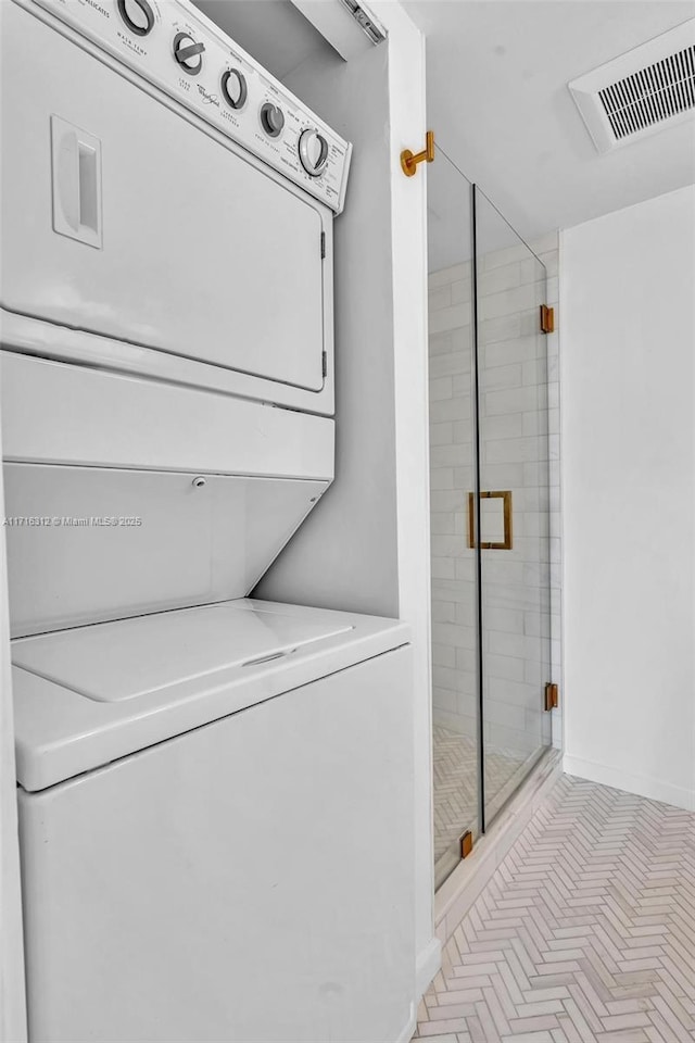 laundry room featuring stacked washer and clothes dryer