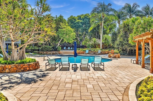 view of pool with a patio and a pergola