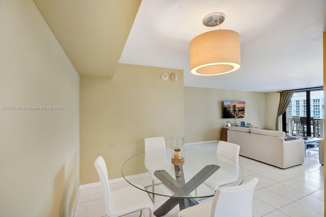 tiled dining space with expansive windows