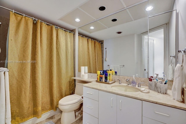 bathroom featuring toilet, vanity, and curtained shower