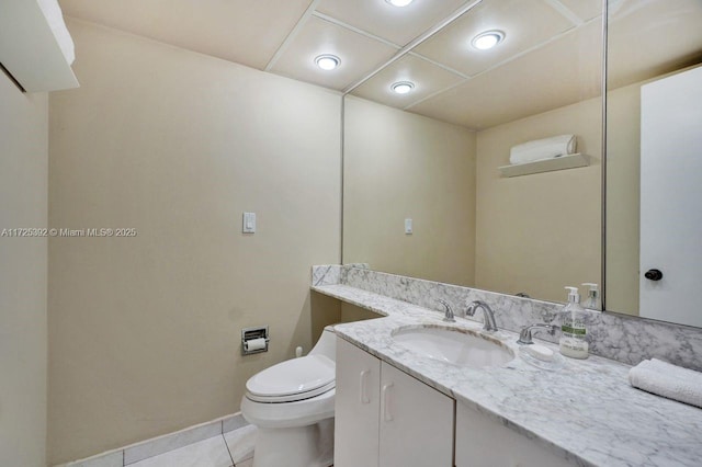 bathroom featuring toilet, vanity, and tile patterned floors