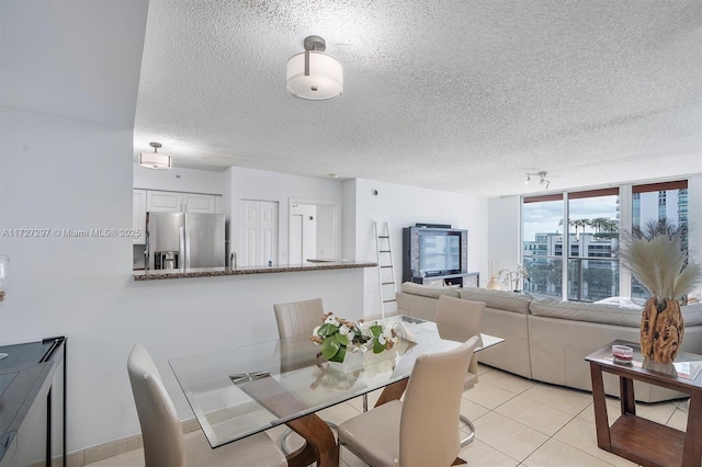 tiled dining room with a textured ceiling