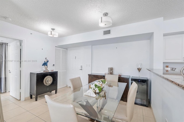 tiled dining area featuring a textured ceiling