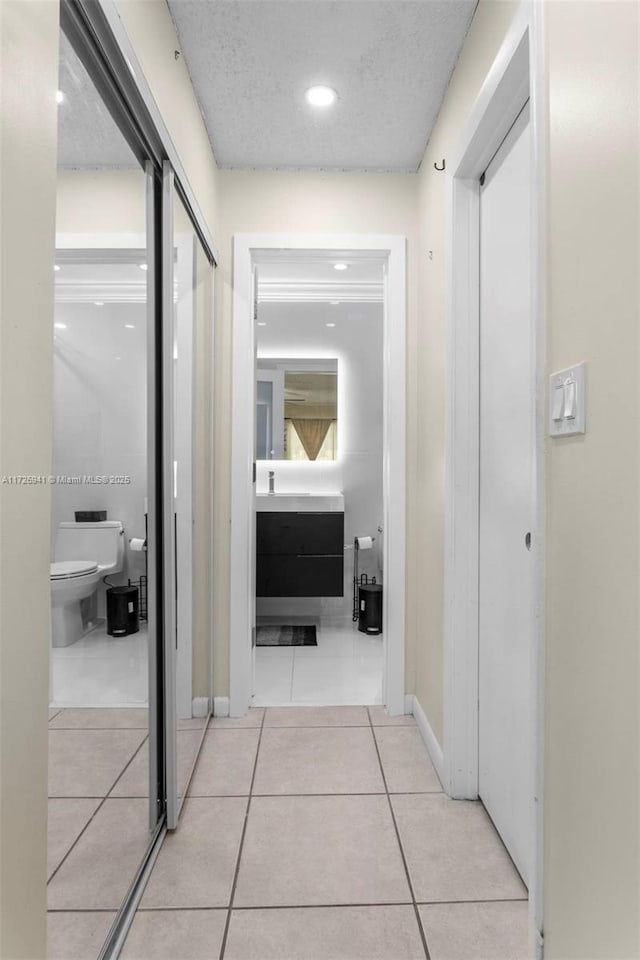 corridor featuring light tile patterned flooring