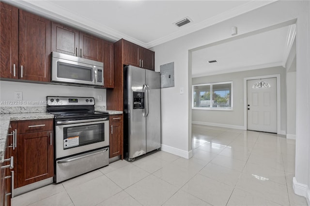 kitchen with light stone countertops, light tile patterned floors, ornamental molding, and stainless steel appliances