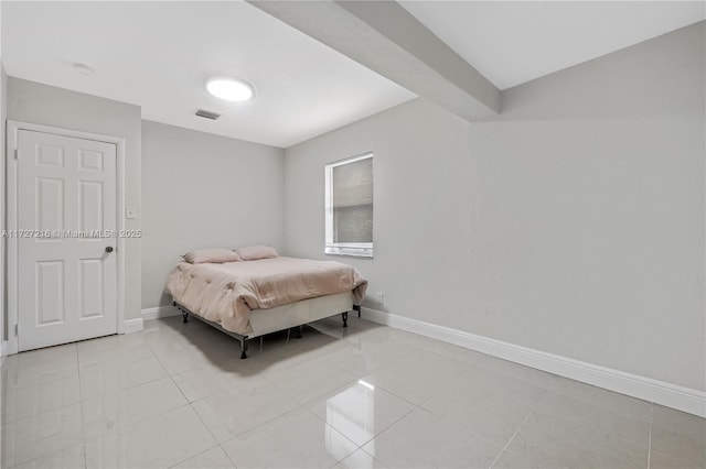 bedroom with light tile patterned floors