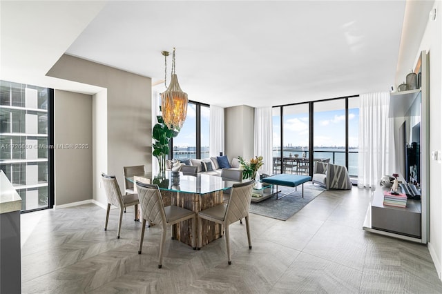 dining area with expansive windows and a chandelier