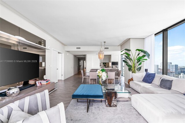 living room featuring expansive windows and parquet floors