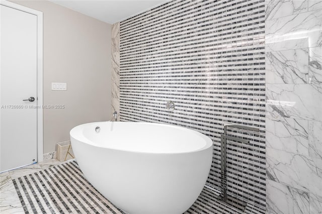 bathroom featuring tile walls and a bathtub