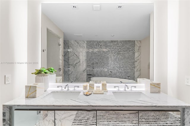 bathroom featuring a shower with shower door and vanity