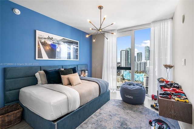 bedroom featuring an inviting chandelier and multiple windows