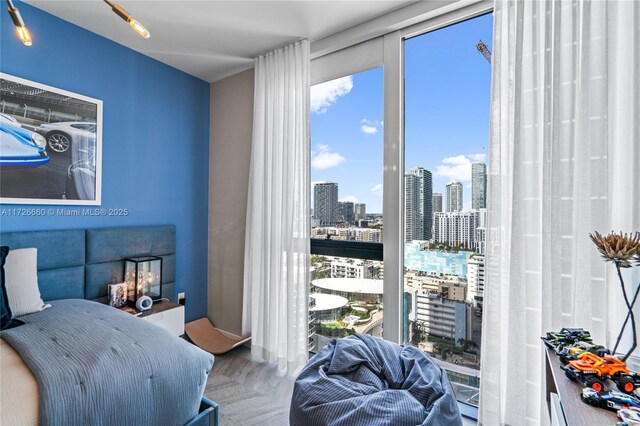 bedroom with expansive windows and parquet floors