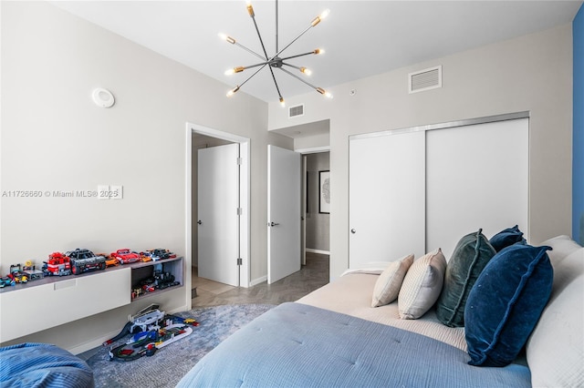 bedroom featuring a closet and an inviting chandelier