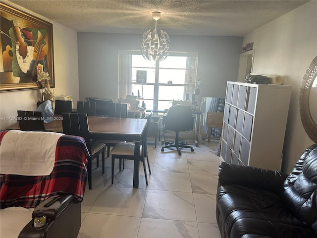 dining area featuring a chandelier and a textured ceiling