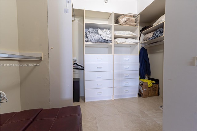 spacious closet with light tile patterned flooring