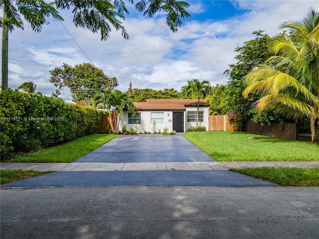 ranch-style house featuring a front lawn