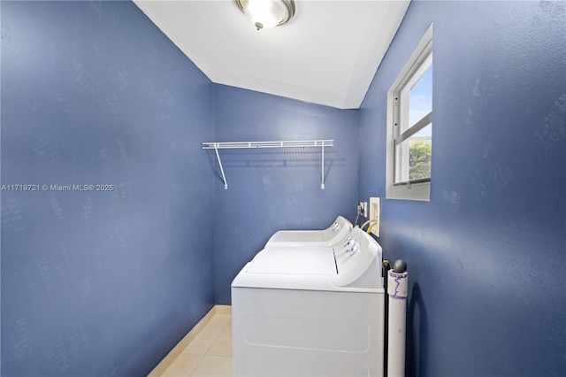 clothes washing area featuring light tile patterned floors and independent washer and dryer