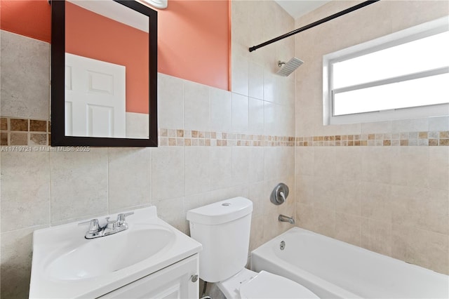 full bathroom featuring tile walls, toilet, vanity, and tiled shower / bath