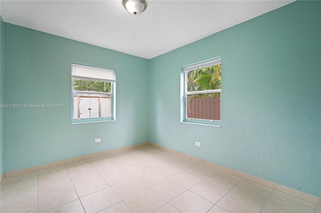 unfurnished room with light tile patterned floors