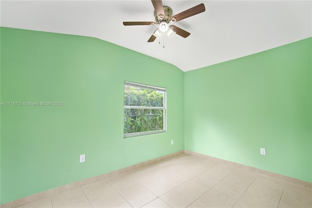 tiled spare room with ceiling fan and vaulted ceiling