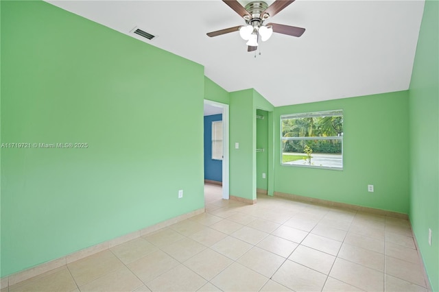 tiled spare room with lofted ceiling and ceiling fan