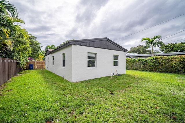 view of side of home featuring a lawn