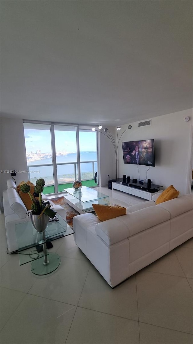 living room featuring floor to ceiling windows and tile patterned floors