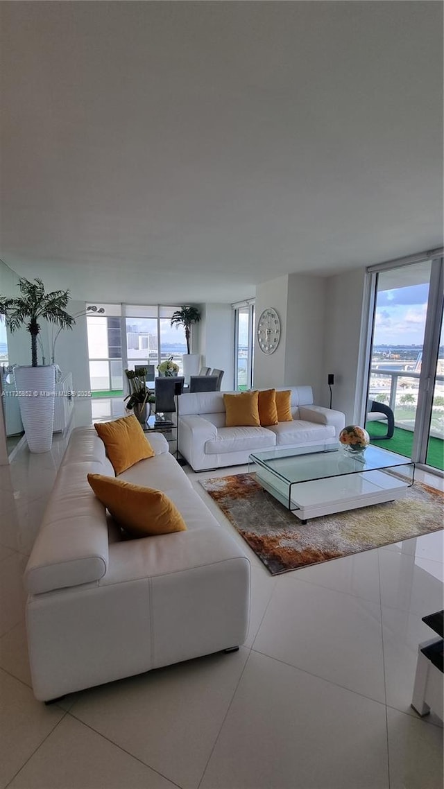 living room featuring floor to ceiling windows and tile patterned flooring