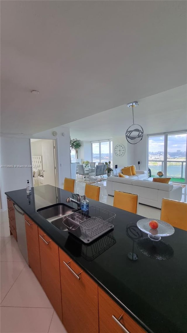 50 Biscayne Blvd Unit 1902, Miami, FL 33132 - kitchen featuring light tile patterned floors, a sink, dishwashing machine, dark countertops, and open floor plan