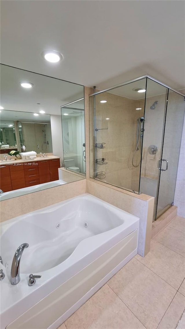 full bathroom with toilet, tile patterned floors, vanity, and independent shower and bath